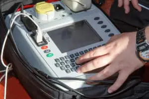 Electrician using PAT Testing machine.